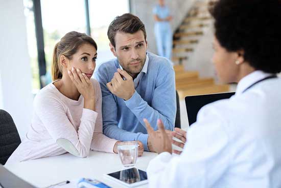 young-couple-having-medical-counseling-with-doctor-clinic